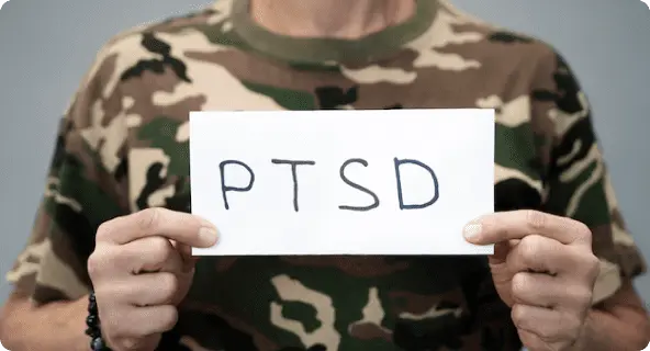 veteran holding sign that says ptsd