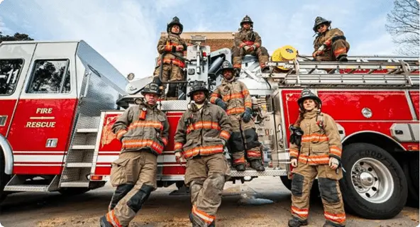 group of firefighters on a firetruck