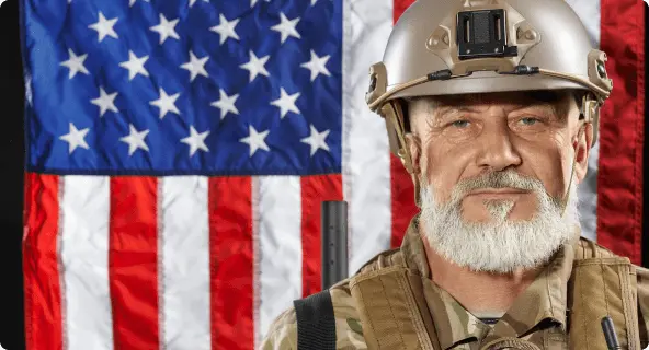 man in military uniform in front of american flag