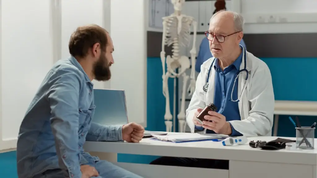Man talking to his doctor with grave concern