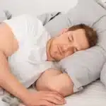 Man sleeping in bed comfortably