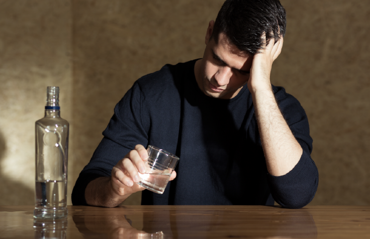 anguished man with a glass of alcohol in his hand