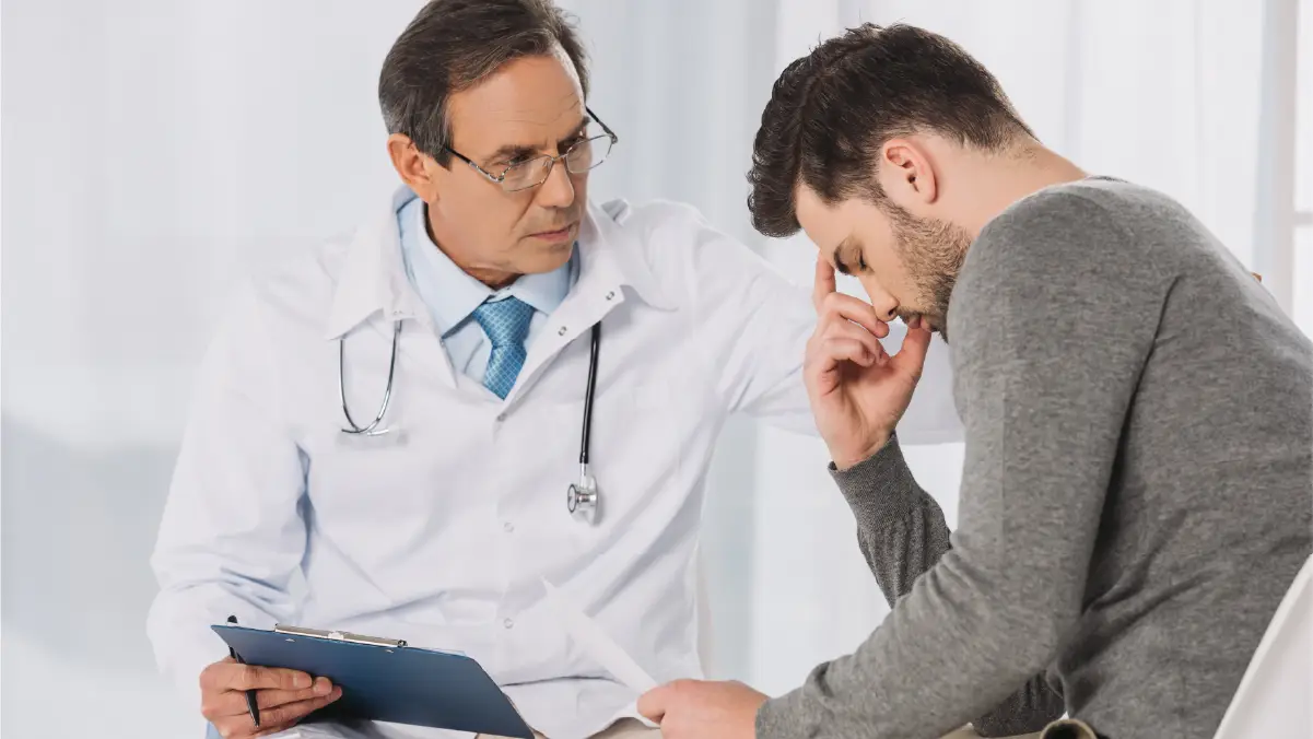 Doctor talking to a distressed patient