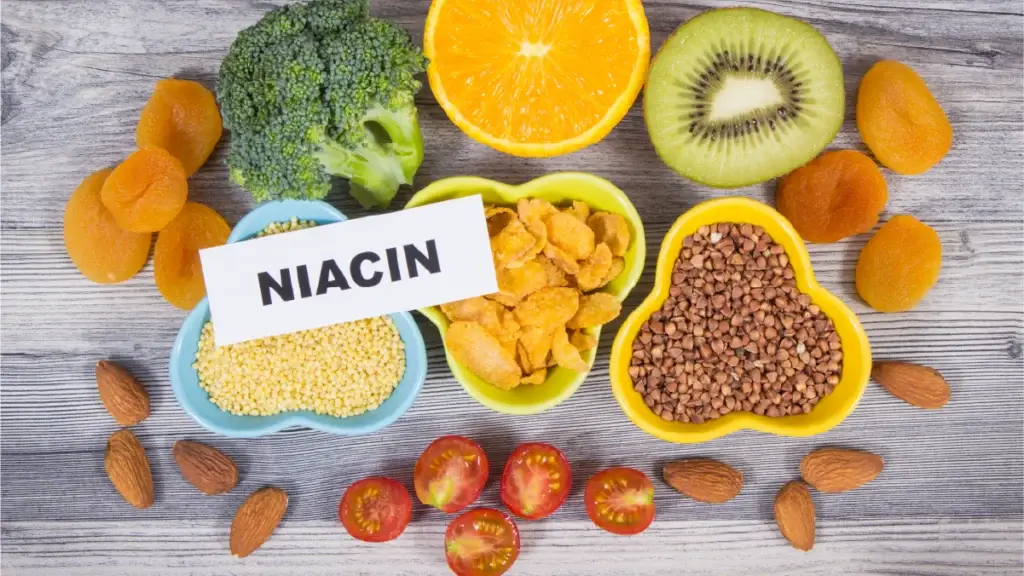 A flat lay of various niacin-rich foods on a wooden surface.