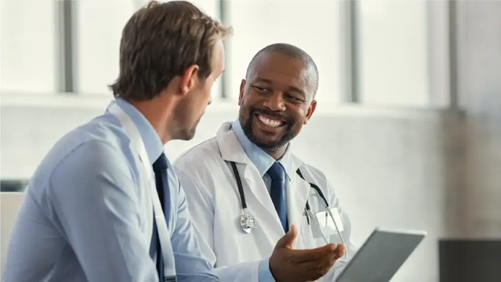 Doctor happily talking to a client