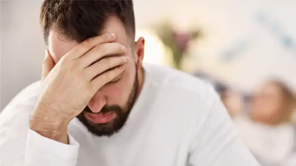Man in distress with his hand on his forehead