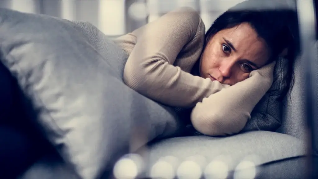 Woman nervously laying down on her side