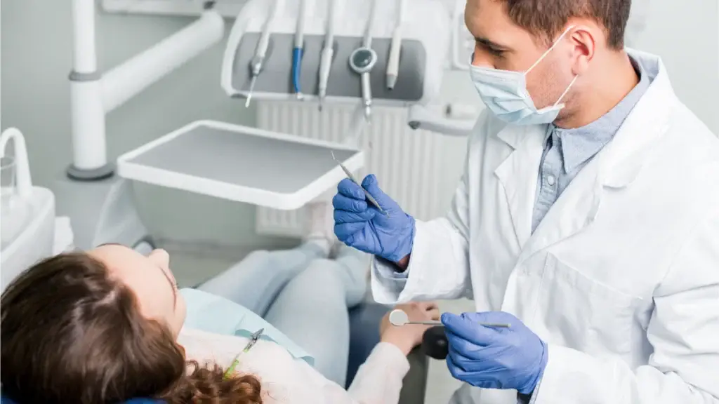 A dentist beginning to do work on a patient's mouth
