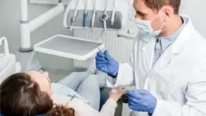 A dentist beginning to do work on a patient's mouth