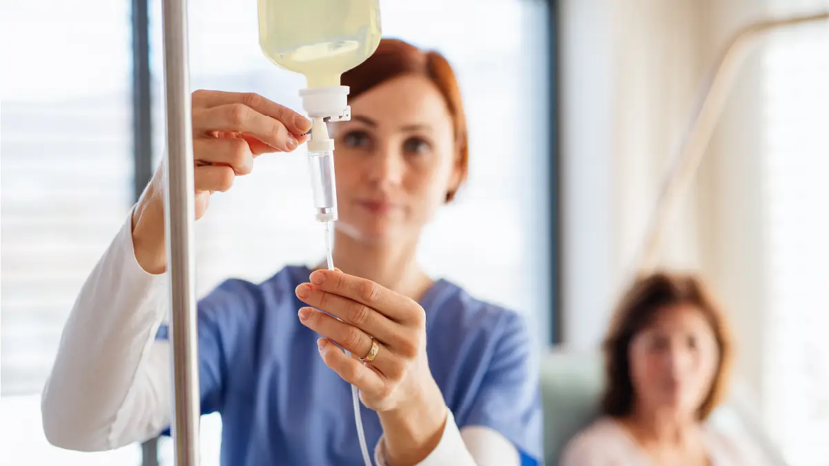 Nurse setting up IV therapy