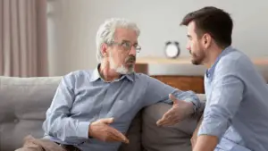 Doctor talking to his patient while sitting on a couch