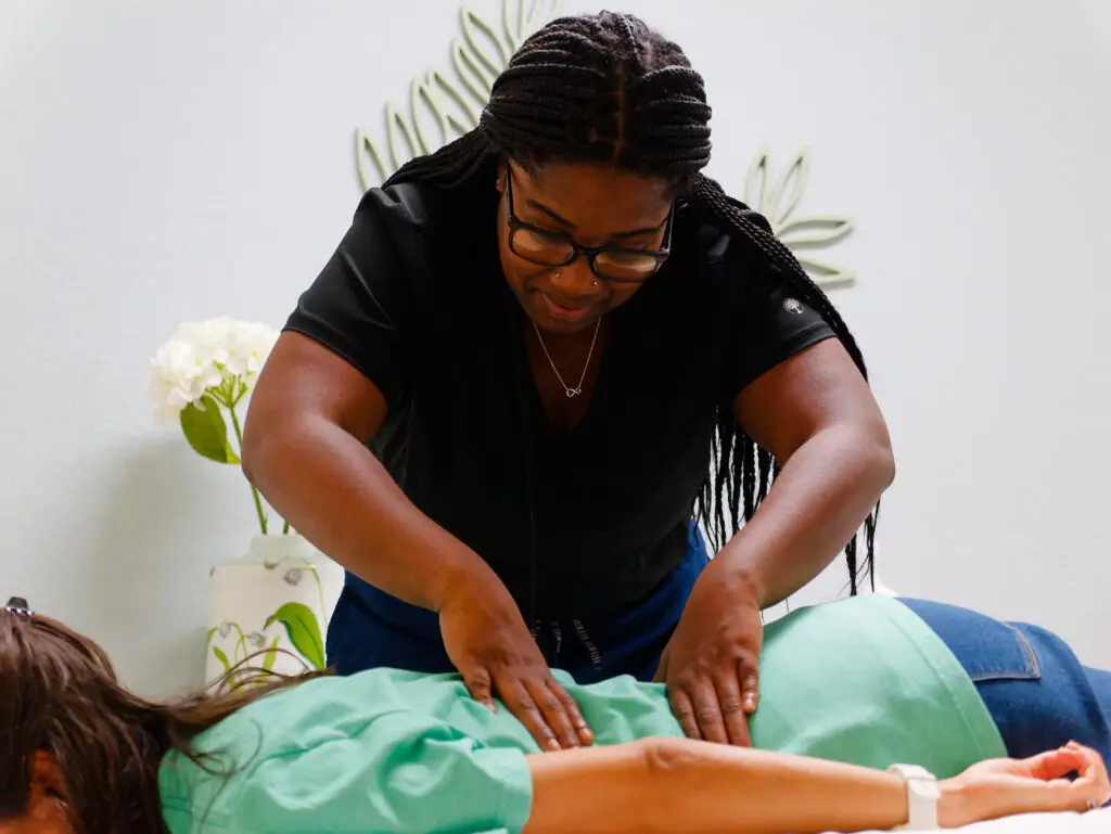 A therapist gives a patient a back massage.