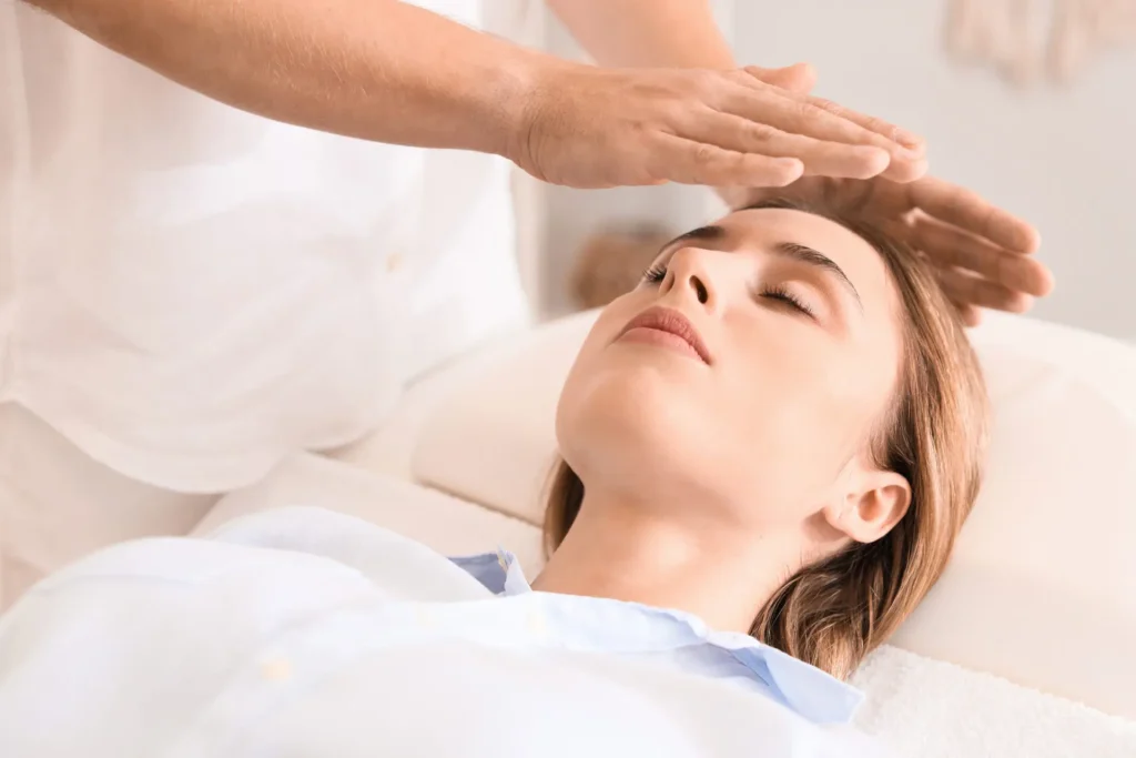 Patient receiving Reiki energy healing therapy as part of holistic addiction recovery at The Haven Detox