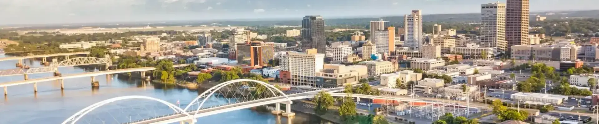 Aerial view of buildings in Arizona and white bridge with river in foreground.