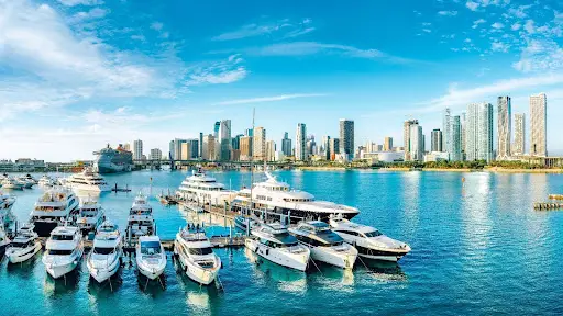 Marina view of Miami skyline with yachts docked in the foreground.