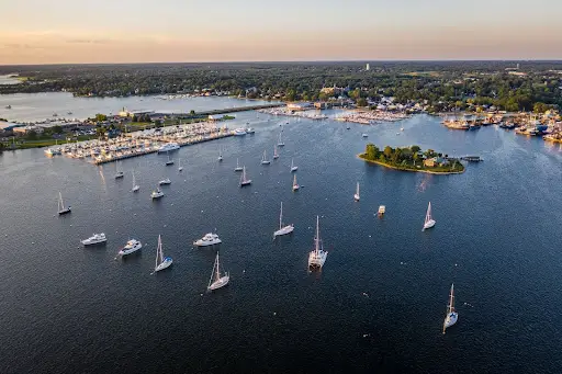 Aerial view of New Bedford, Massachusetts harbor with sailboats on the water.