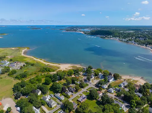An aerial shot of a large body of water and a beach in Quincy Massachusetts