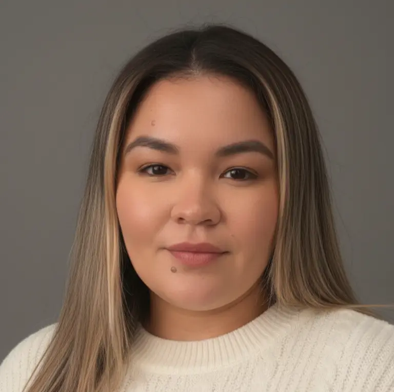 Portrait of a woman with long hair wearing a white sweater.