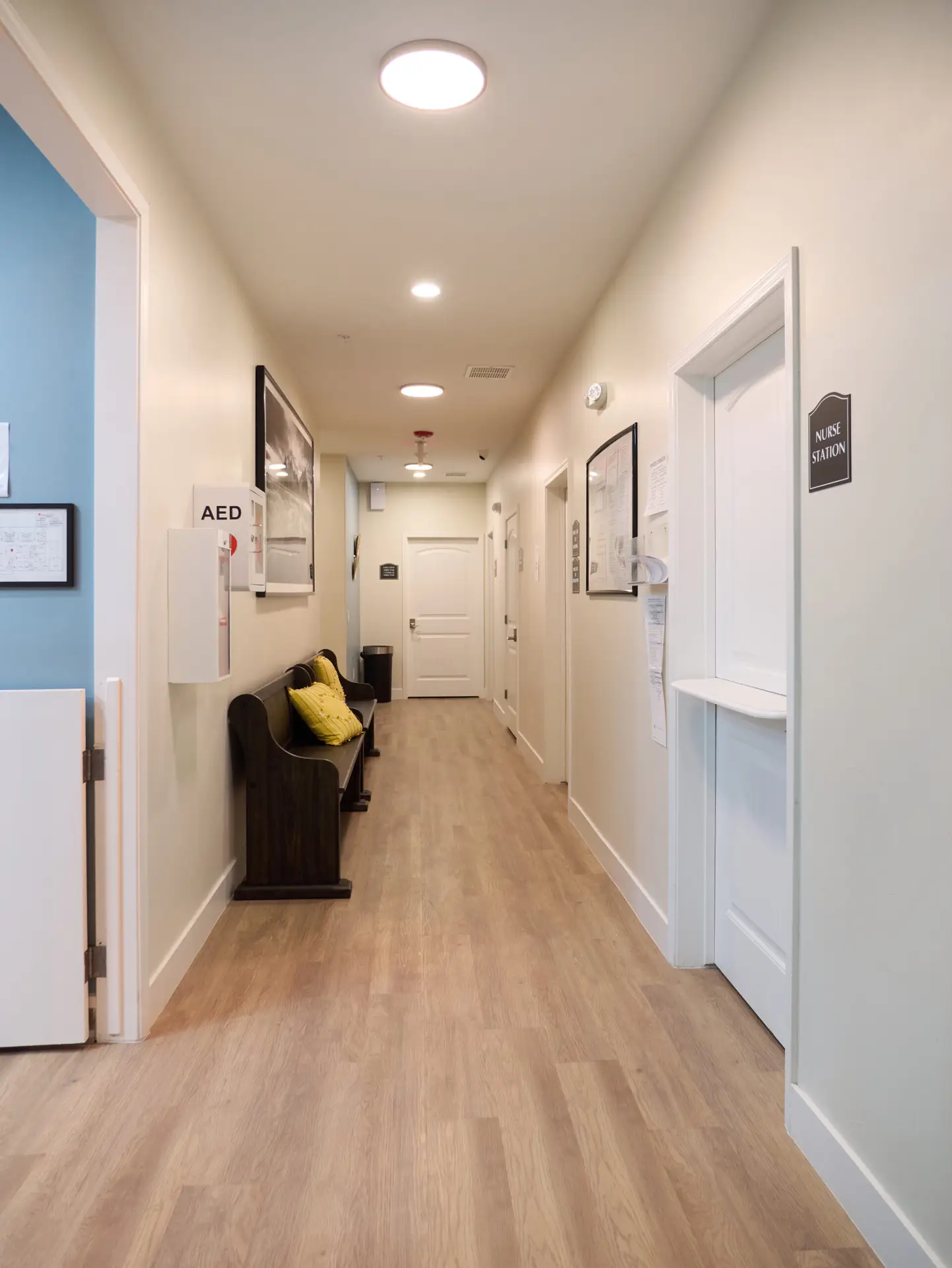 Interior hallway with bench seating and nurse station at The Haven Detox Arizona