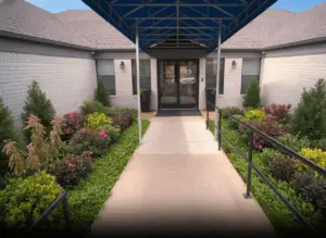 Front entrance of The Haven Detox Little Rock rehab facility with plants and accessible walkway