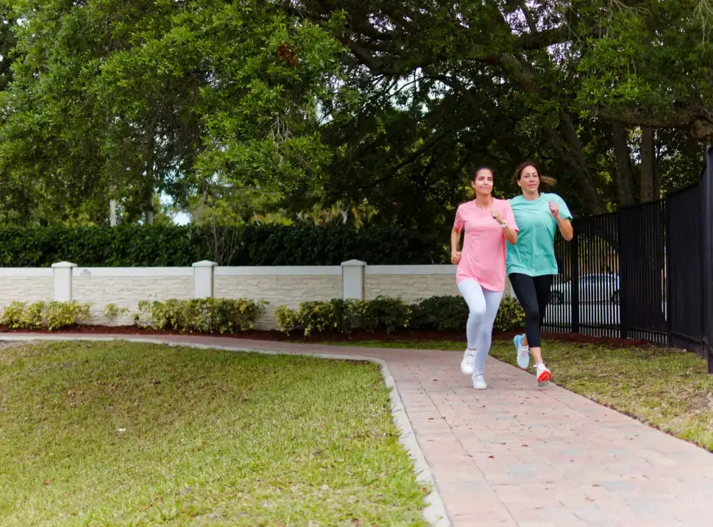 Residents jogging together along a paved walking path at The Haven Detox, promoting fitness and outdoor wellness during recovery.