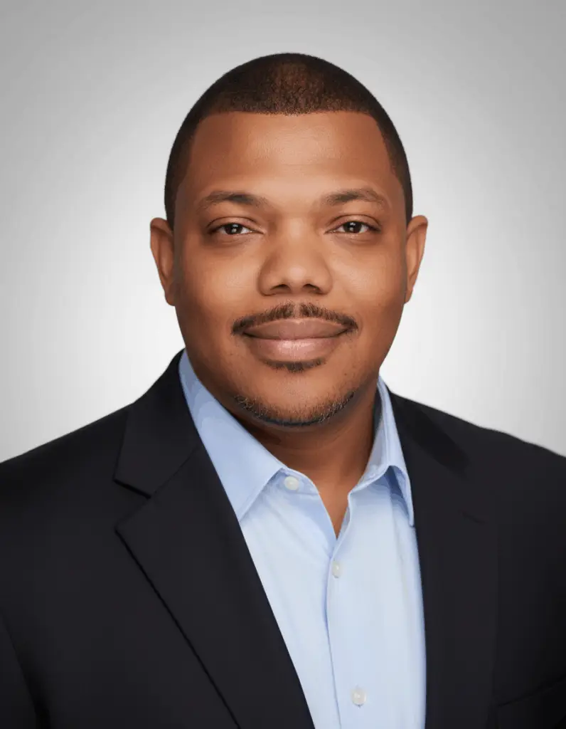 Professional headshot of a man wearing a dark blazer and light blue dress shirt, photographed against a neutral background and associated with Haven Detox Oklahoma addiction treatment services.