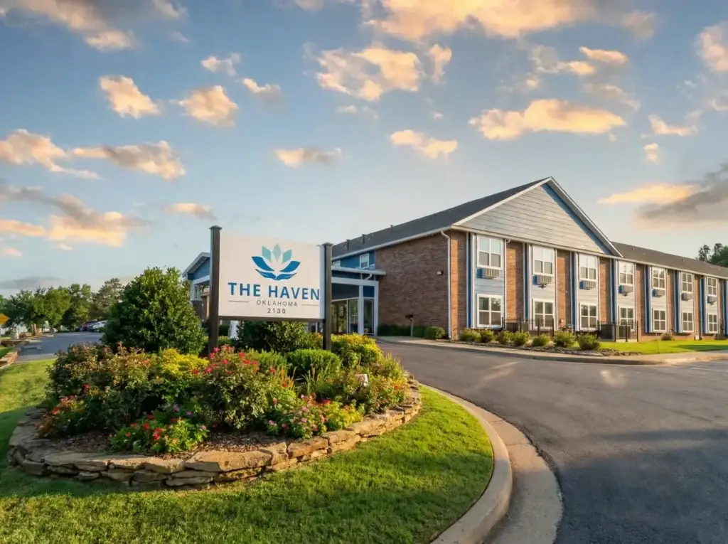 Entrance signage at The Haven Detox Oklahoma surrounded by flowers and warm exterior colors