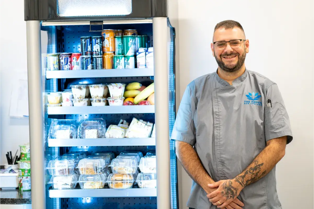 Chef standing beside the healthy snack and beverage station available to patients at The Haven Detox Massachusetts in Worcester, Massachusetts.