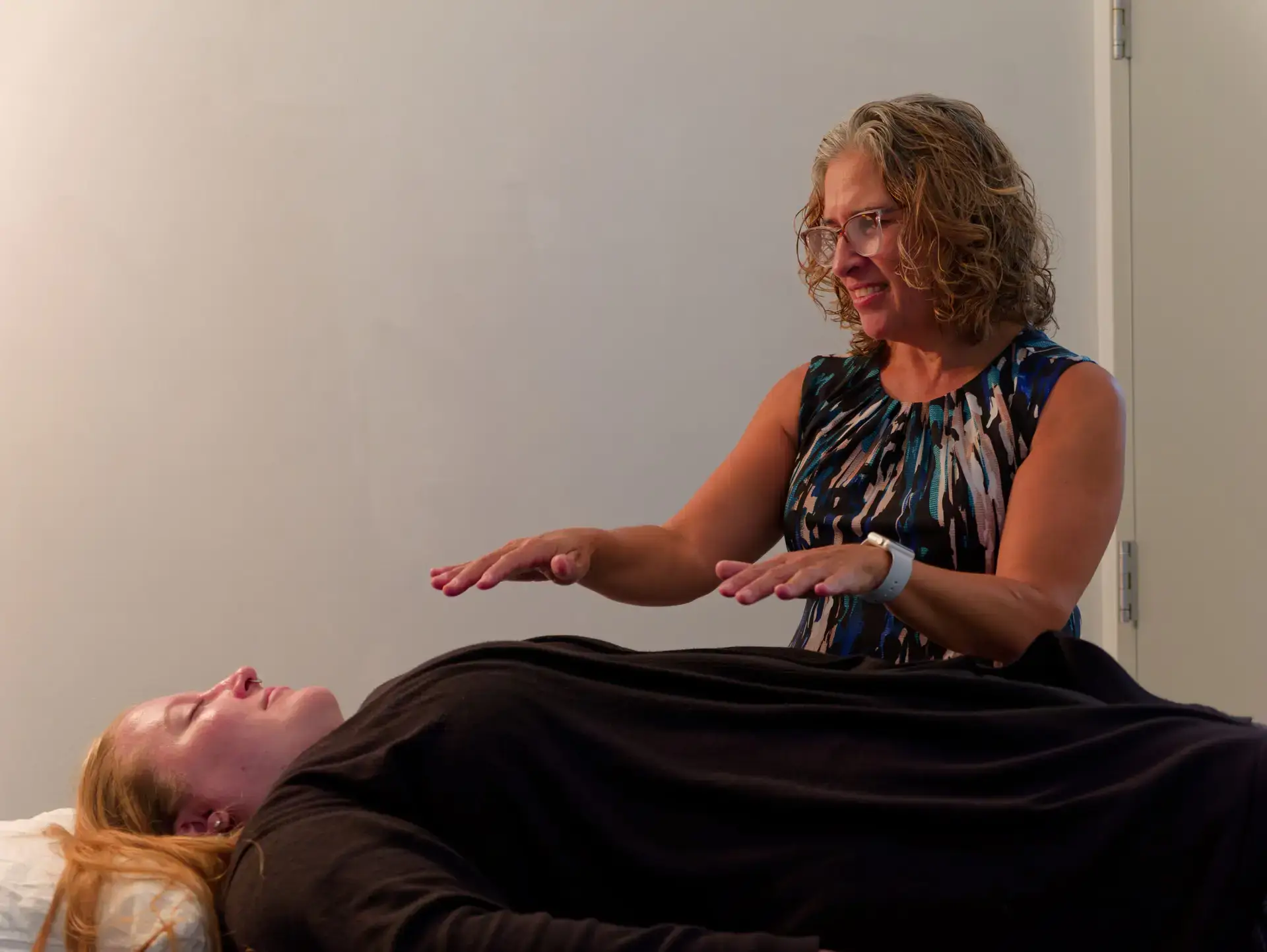 Holistic therapist providing an energy healing session to a patient at The Haven Detox Massachusetts in Worcester, Massachusetts.